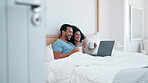Laptop, drinking coffee and laughing with a couple in bed together in the morning to relax in their home. Tea, computer or video with a man and woman watching a movie in their apartment bedroom