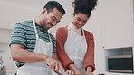 Love, food and a couple cooking in the kitchen of their home together for a romantic meal on their anniversary. Smile, health or nutrition with a happy man and woman preparing vegetables in a house