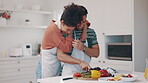 Hug, food and a couple in the kitchen for cooking at home together for a romantic meal on their anniversary. Diet, love or smile with a happy man and woman preparing healthy vegetables in a house