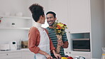 Couple, home and flower bouquet or surprise for anniversary, valentines day or birthday. A happy man and woman together in kitchen while cooking food and giving flowers to celebrate love and marriage