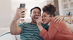 Couple, selfie and laugh on sofa, home and heart fingers, sign language and icon for post on blog. Man, woman and smile on web, happy memory and profile picture with emoji, social network on couch