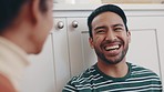 Face, couple and laugh in home for conversation, talking and chat together for love, care and happy relationship. Asian man smile with woman for funny joke, communication and discussion in apartment