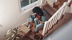 Tablet, real estate and couple on the stairs of new house for planning renovation, research or moving idea from above. Property, success and homeowner people online for relocation service app review