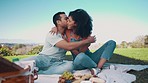 Love, picnic and food with couple in nature for summer vacation, relax and happiness. Bonding, kiss and commitment with man and woman on date in park for wellness, romance and anniversary together