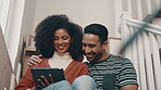 Tablet, couple and smile on stairs in home, bonding and streaming funny video online together. Technology, interracial man and woman on steps for internet, social media or laughing at meme on website