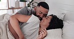 Happy, relax and couple hug in bed with care, conversation and resting in their home together. Waking up, love and happy man with woman in a bedroom cuddle, romantic and lying, speaking and smile