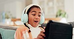 Home, happy and girl with headphones, tablet or connection with video games, excited or app. Person, kid or child with technology, headset or entertainment with fun, playing online or streaming music