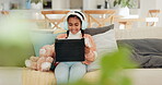 Girl, child and happy for tablet, headphones and relax on sofa for online video games, watching funny movies or elearning. Kid, laugh and digital tech for listening to music, streaming app or cartoon