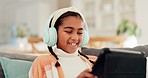 Girl, kid and tablet with headphones on sofa for online video games, watching funny movies and play educational app. Happy child laugh with digital technology, listening to music or streaming cartoon