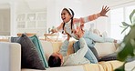 Mom, girl and child on sofa for airplane games, smile and relax at home for crazy fun. Happy mother lifting excited kid to fly in living room for freedom, fantasy and balance for play, care or energy
