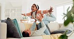 Mother, girl or kid in home for airplane games, smile or relax on sofa for or crazy fun. Happy mom lifting excited child to fly in living room for freedom, fantasy or balance for play, care or energy