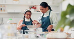 Girl, helping and mom teaching cooking in kitchen or learning, baking with flour in home with family recipe or knowledge. Child, help and mother show kid how to bake a cake, dessert or cookies