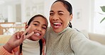 Selfie, silly and mother with her child in the living room for comic, goofy or funny face. Happy, smile and portrait of a young mom taking picture with girl kid for bonding or memory together at home