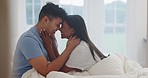 Love, nose touch and couple in bedroom, happy and bonding together in the morning. Smile, intimate and interracial man and woman in bed for healthy relationship, romance or care in commitment at home