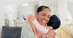 Love, happy and mother hugging her child in the living room of modern home in the morning. Smile, bonding and girl kid embracing her young mom from Colombia for greeting in the lounge of family house