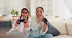 Playing video game, mother and daughter on sofa, fun and relax in home living room with internet, controller and esports. Online gaming, technology and excited girl with mom on couch on virtual app.