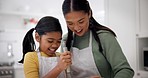 Mother, girl and happy cooking in kitchen for love, care and learning recipe for dessert, food and baking. Child, mom and smile for helping to whisk ingredients, teaching kid how to bake at home 