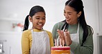 Cake, candles and baking cheer with child and mom together with helping in a kitchen. Happy, parent support and birthday food for rainbow dessert in family home with clapping and cooking with mother