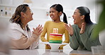 Party, family singing happy birthday to a girl and a senior woman with her daughter in the kitchen of a home. Cake, applause or celebration with a grandmother, mother and girl clapping in excitement