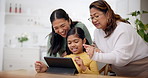 Grandmother, mother and daughter on a tablet as a family playing a game in the living room of their home together. Love, education or internet with a senior woman and girl teaching a kid online