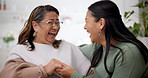 Laughing, talking and a mother with a daughter on the sofa for gossip, secret or conversation. Happy, funny and a senior mom speaking to a woman about a joke or comic story on a home couch together