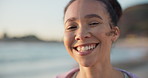 Face, smile and freedom with a woman on the beach for travel, freedom or adventure in the morning. Portrait, summer and wellness with a happy young female tourist by the ocean or sea for vacation