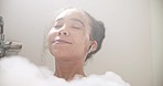 Music, relax or happy woman in home bath cleaning, grooming or body care in soap foam. Face, earphones or calm person lying in water in spa, house or bathroom streaming or listening to radio or song