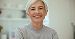 Excited, smile and face of senior woman at a home with sweet, cute and positive personality. Happy, headshot and portrait of elderly female person in retirement laughing at funny comic joke at house.