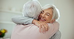 Hug, welcome and senior woman friends in the living room of their home during a visit in retirement. Smile, love and a happy elderly person embracing her sister while feeling excited together