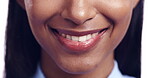Smile, mouth and face of a woman in studio for happiness, positive attitude and kindness. Zoom on teeth of a female model person for wellness, dental health and natural cosmetics on lips and skin