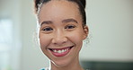 Face, smile and a woman caregiver in an assisted living home for healthcare, help or senior care. Portrait, medical and support with a happy young nurse in the living room of a house closeup