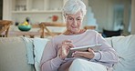 Relax, tablet and senior woman on sofa in living room scroll on social media, mobile app or the internet. Rest, online and elderly female person browsing on website with technology in lounge at home.