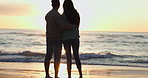 Couple, people and hug at sunset on beach in miami for romantic holiday, travel and vacation to bond. Sunrise, man and woman stand together on sea sand in nature for honeymoon, happiness and relax