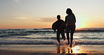 Ocean beach, sunset and silhouette of couple running, having fun and bonding on tropical adventure journey. Water, sea waves and dark marriage people walking on travel holiday, vacation or honeymoon