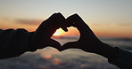 Heart hands, sunset and silhouette of a couple on the beach together for dating, romance or travel. Love, sky and nature with people outdoor by the ocean or sea for peace, wellness or support