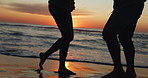 Sunset, dancing and legs of couple on a beach for vacation or tropical holiday together for love or care. Silhouette, man and woman with happiness on anniversary with travel freedom at ocean