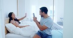 Couple, smile and photography on phone in bedroom, bonding in the morning and playing. Smartphone, picture and man and woman in bed, happy and funny laugh on social media to relax together in home