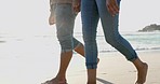 Legs, holding hands and couple walking on beach, relax or bonding on summer island holiday together. Romance, man and woman on tropical ocean vacation, love and barefoot date on sand in Indonesia.