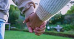 Couple holding hands in park for love, care and relax on romantic date together in nature. Closeup of man, woman and partner in garden for freedom, loyalty and commitment to support in relationship 