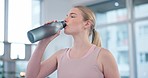 Woman, home and drink of water for sports break, energy and workout performance. Thirsty athlete, bottle and nutrition of hydration, diet or healthy liquid for training, exercise or fitness in lounge