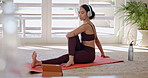 Woman, yoga and pilates in online class, fitness or zen workout on mat with headphones in living room at home. Calm female person or yogi in body warm up, stretching or tablet for tutorial or lesson