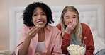Television, comic and women friends on a bed with popcorn for movie, comedy or standup show at home. Surprise talk show and ladies watching tv in bedroom laugh, snack and relax with streaming service