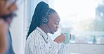 Black woman, call center and drinking coffee in customer service, support or telemarketing at the office. African female person, consultant or agent enjoying hot beverage in contact us at workplace