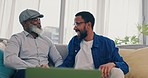 Father, son and fun handshake in home with bonding, care and love of African family together. Senior man, dad and support on a living room couch with conversation and communication on a lounge sofa