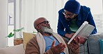 Discussion, book and man with his senior father on a sofa in the living room for knowledge. Conversation, story and young African male person talking to his elderly dad about novel in lounge at home.