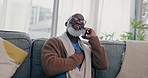 Home, phone call and senior man on a couch, smile and connection with communication, conversation and network. African person, pensioner or guy with a smartphone, discussion or retirement in a lounge