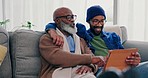 Senior father, black man and talking with laptop at home with conversation, bonding and watching series. Living room, elderly male person and communication with streaming and discussion in a house