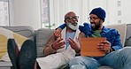 Home, father and son on a couch, tablet and conversation with connection, social media and chatting. People, black men or relax on a sofa, technology or search internet with discussion or digital app