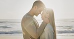 Love, hug and couple at a beach with trust, romance and support at the ocean for travel or summer vacation. Care, embrace and man with woman at sea with lens flare, intimacy and outdoor weekend trip