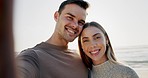 Selfie, happy and couple hug at beach for travel, vacation or photo memory on holiday in nature. Portrait, love and man with woman at sea smile for social media, profile picture or bond on ocean trip